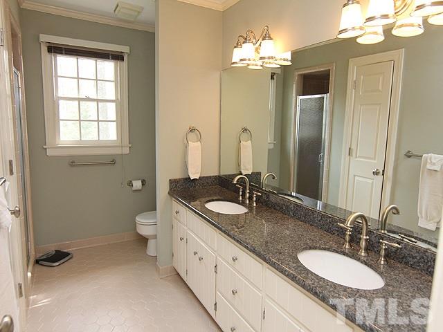 8013 Shellnut Road Raleigh, NC 27615 - Photo 14 of 25 a bathroom with a granite countertop double vanity sink and a mirror