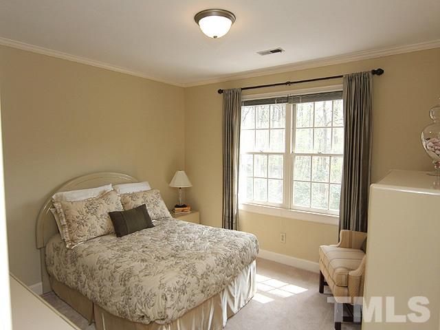 8013 Shellnut Road Raleigh, NC 27615 - Photo 17 of 25 a bed sitting in a bedroom next to a window