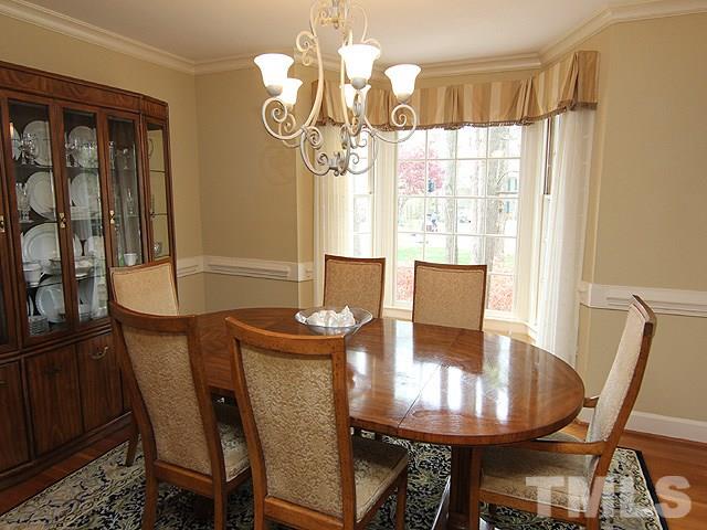 8013 Shellnut Road Raleigh, NC 27615 - Photo 7 of 25 a view of a dining room with furniture window and wooden floor