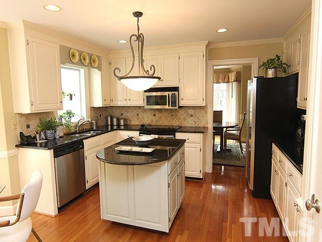 8013 Shellnut Road Raleigh, NC 27615 - Photo 8 of 25 a kitchen with a sink stove and refrigerator