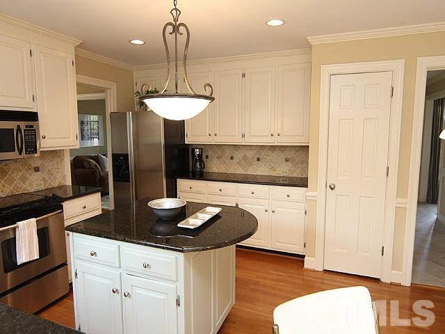 8013 Shellnut Road Raleigh, NC 27615 - Photo 9 of 25 a kitchen with stainless steel appliances granite countertop a stove and a refrigerator