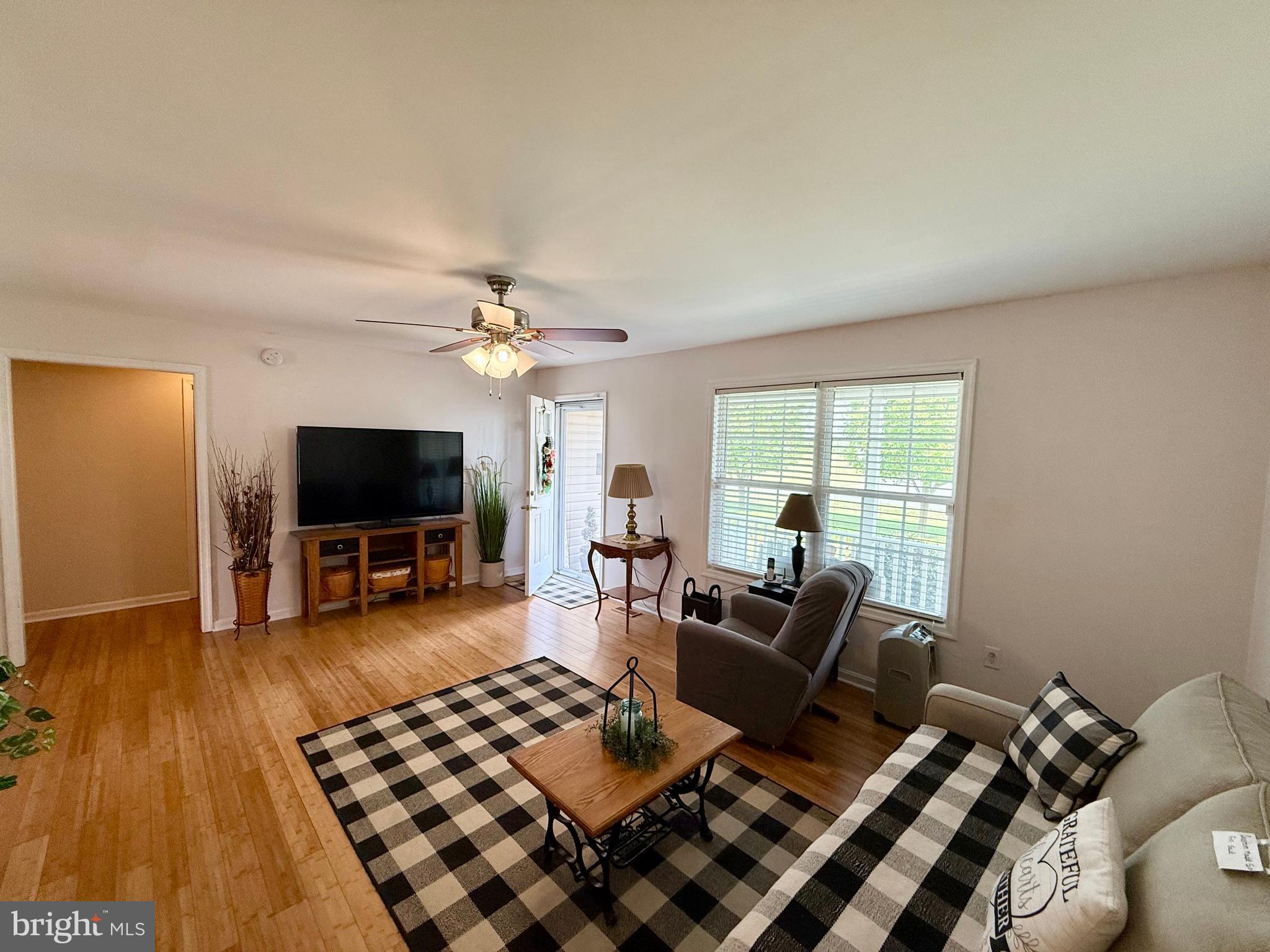 11684 Kensington Way Laurel, DE 19956 - Photo 12 of 43 a living room with furniture a flat screen tv and a large window