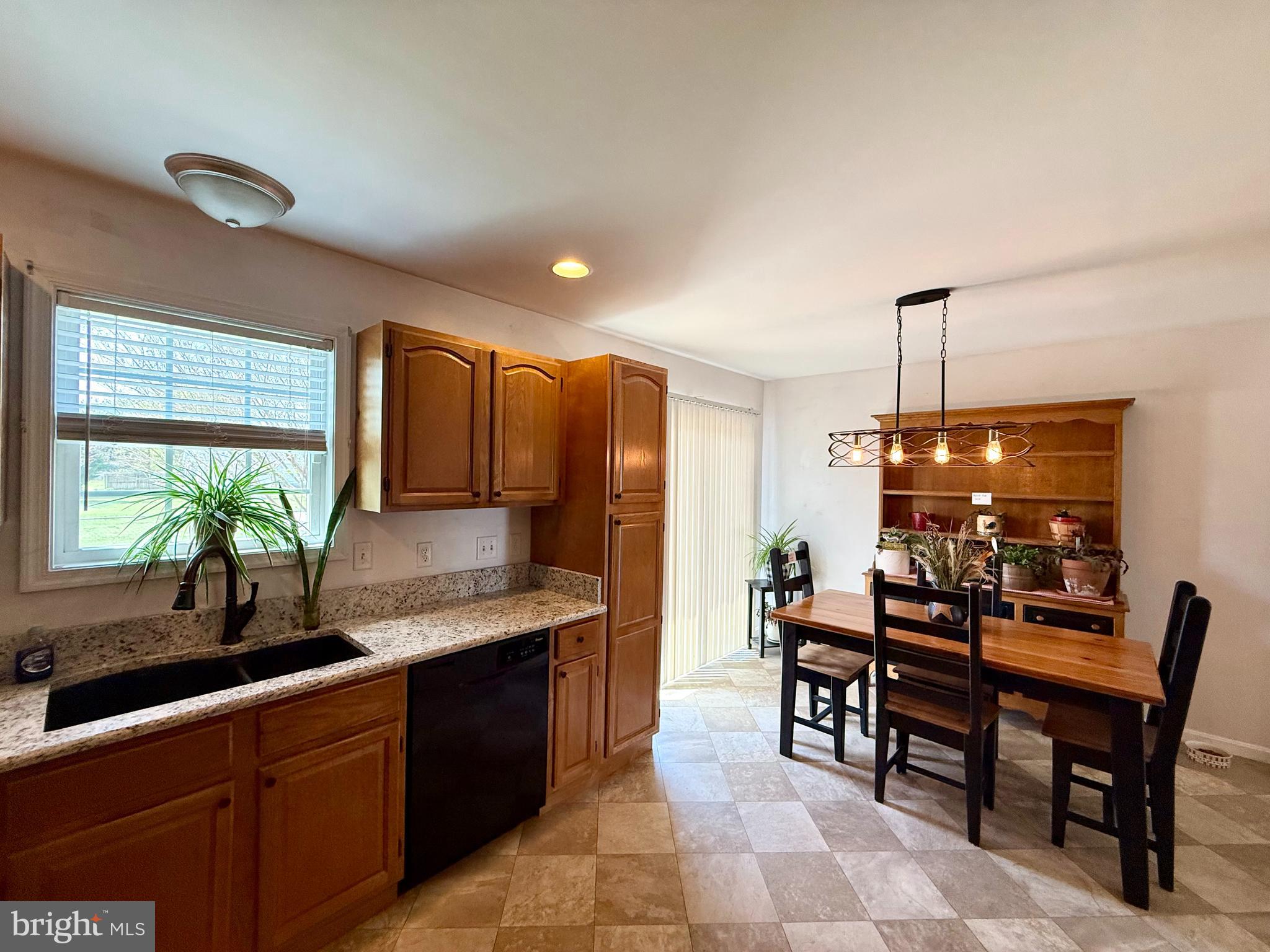 11684 Kensington Way Laurel, DE 19956 - Photo 19 of 43 a kitchen with granite countertop sink table and chairs