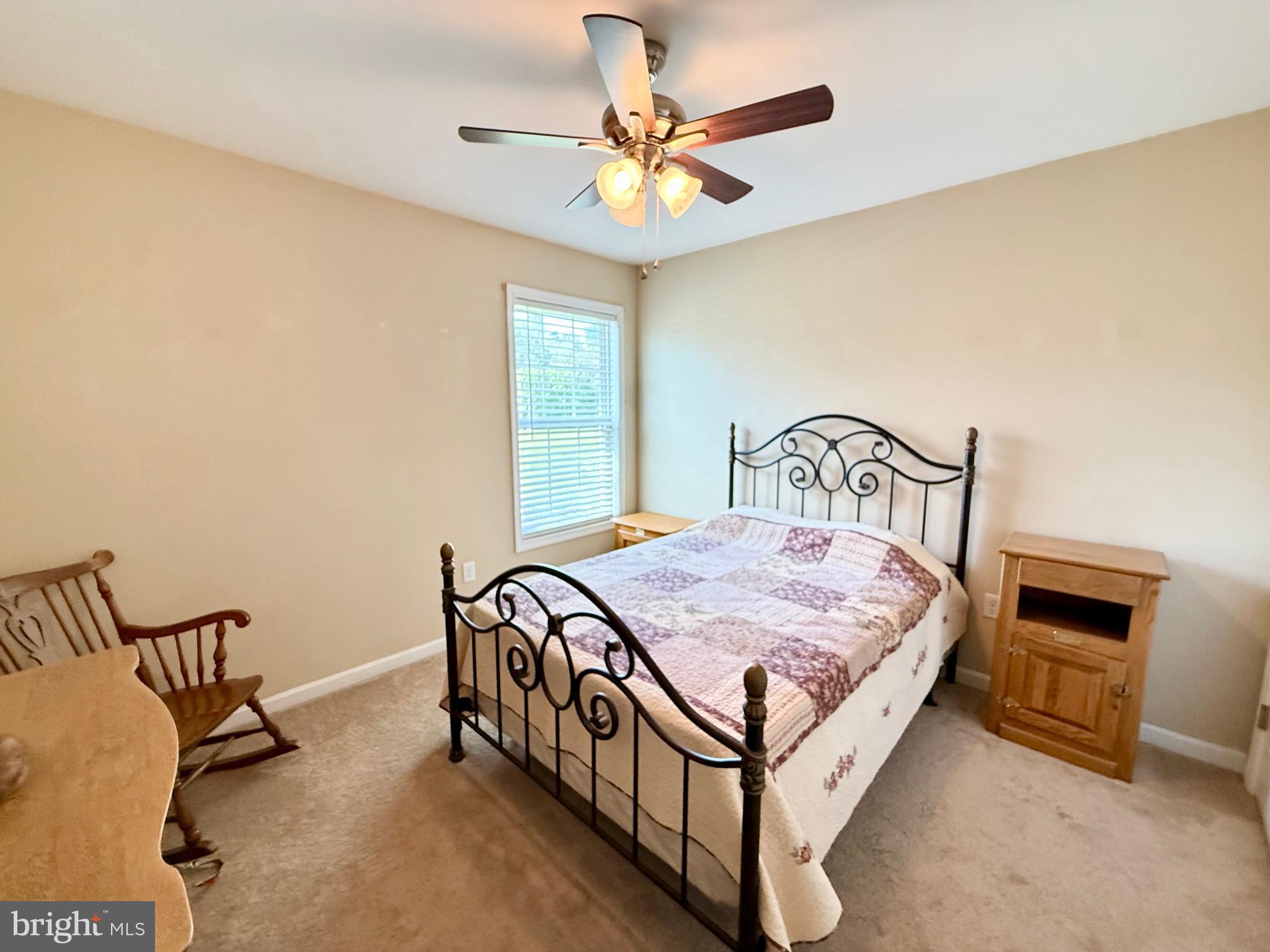 11684 Kensington Way Laurel, DE 19956 - Photo 20 of 43 a bedroom with a bed and a chandelier