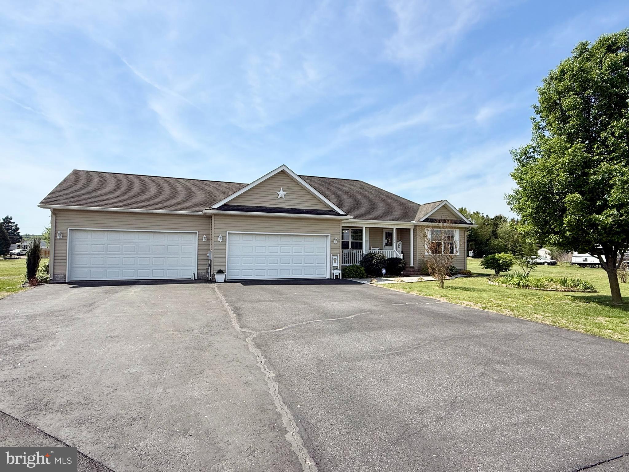 11684 Kensington Way Laurel, DE 19956 - Photo 2 of 43 a front view of a house with a yard and garage
