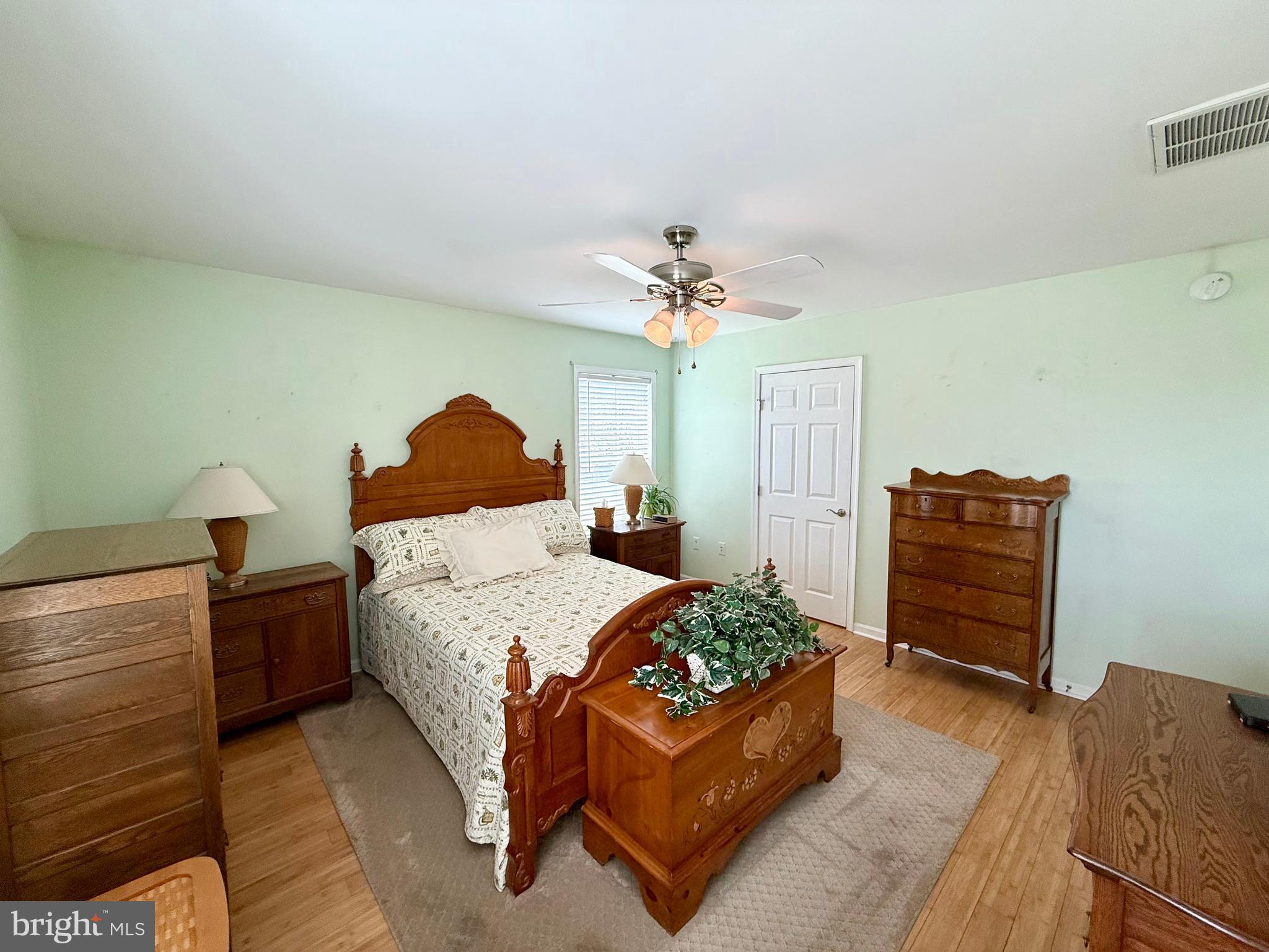 11684 Kensington Way Laurel, DE 19956 - Photo 31 of 43 a bedroom with a bed and a chandelier