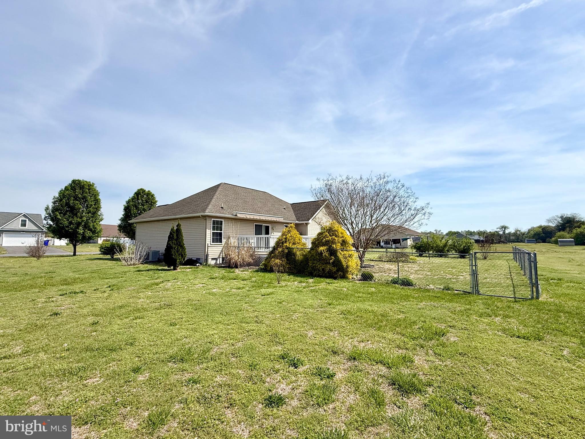 11684 Kensington Way Laurel, DE 19956 - Photo 41 of 43 a yellow house with a big yard and large trees