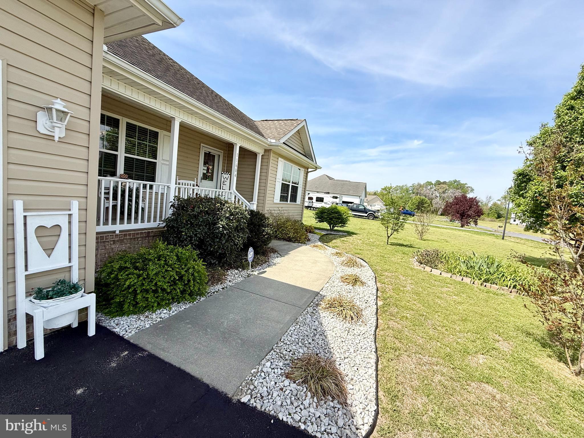 11684 Kensington Way Laurel, DE 19956 - Photo 7 of 43 a view of a house with a yard and potted plants