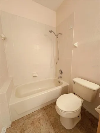 a bathroom with a toilet and a bath tub