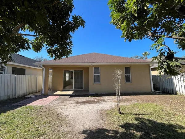 a house that has a tree in front of the house