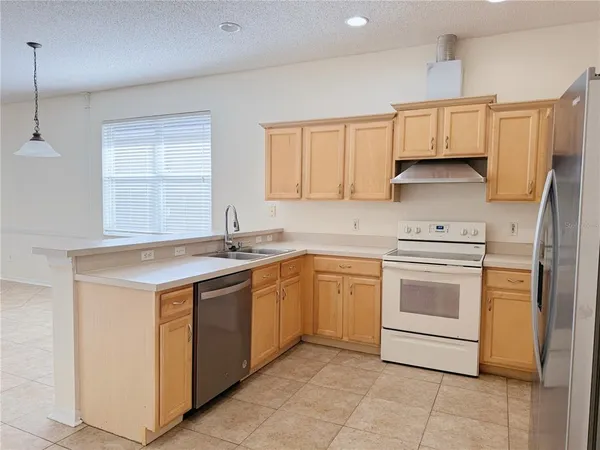 a kitchen with a stove sink and cabinets