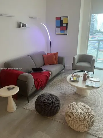 a living room with furniture and a dining table