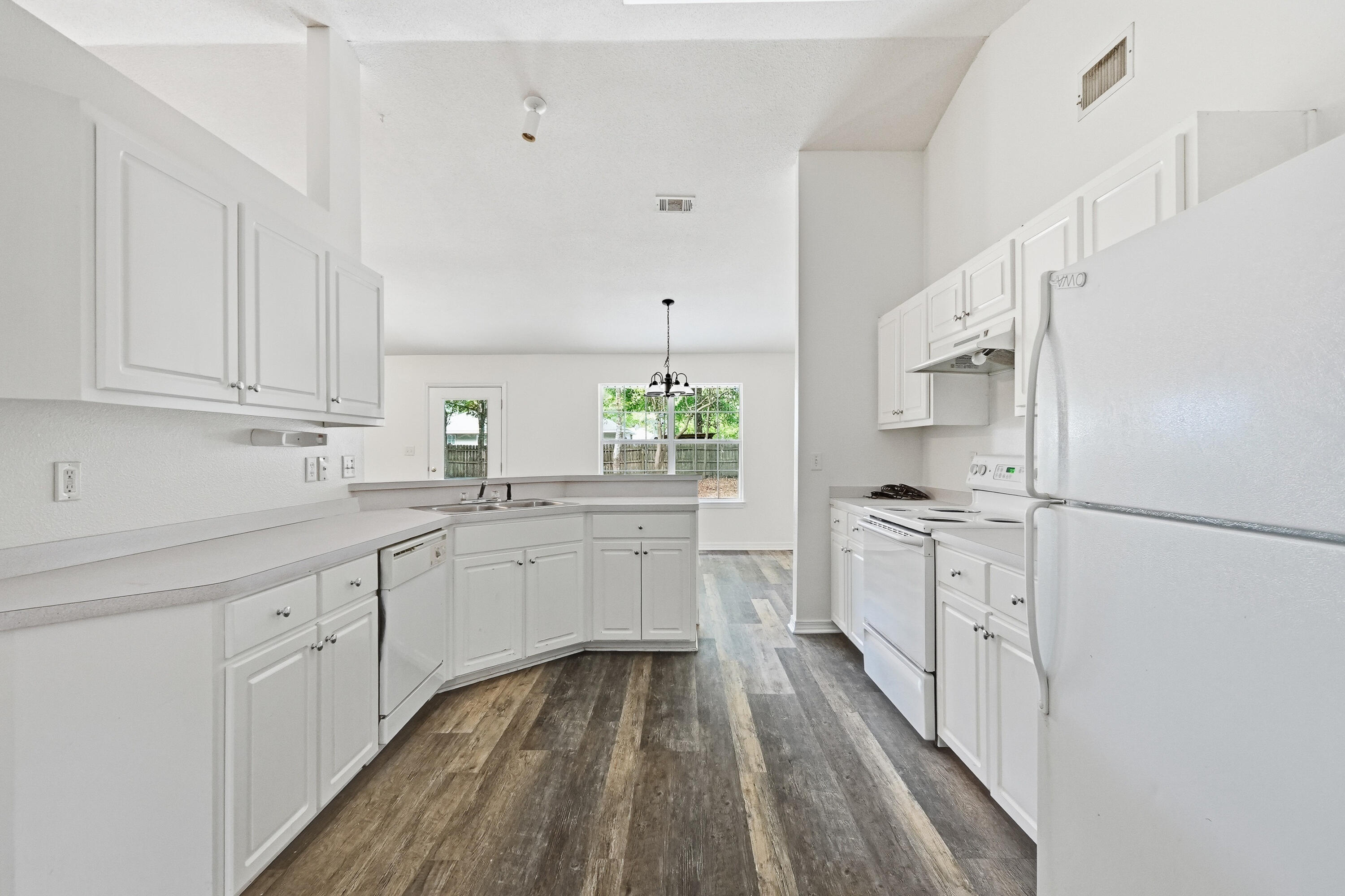 4087 Audiss Road Milton, FL 32583 - Photo 17 of 34 a kitchen with white cabinets and white appliances