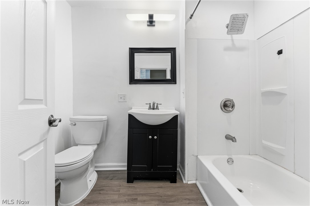 563 Geneva Avenue Struthers, OH 44471 - Photo 13 of 31 Full bath featuring vanity, wood finished floors, and bathtub / shower combination