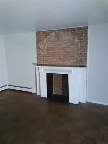 a view of empty room with a fireplace