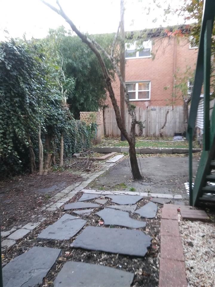 220 Garden Street, Unit 1(GRND) Hoboken, NJ 07030 - Photo 8 of 9 a view of a house with backyard and trees