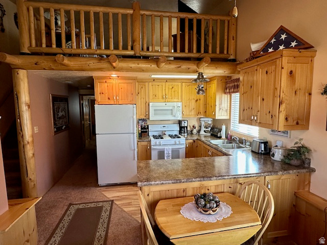 1454 East Little Sweden Road Heber City, UT 84032 - Photo 19 of 35 Kitchen with a peninsula, white appliances, a breakfast bar area, dark countertops, and a high ceiling