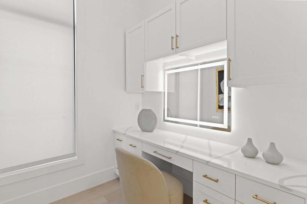 7117 Davenport Divide Road Austin, TX 78738 - Photo 27 of 40 A well-lit vanity area offers abundant storage with sleek cabinetry and a radiant mirror.