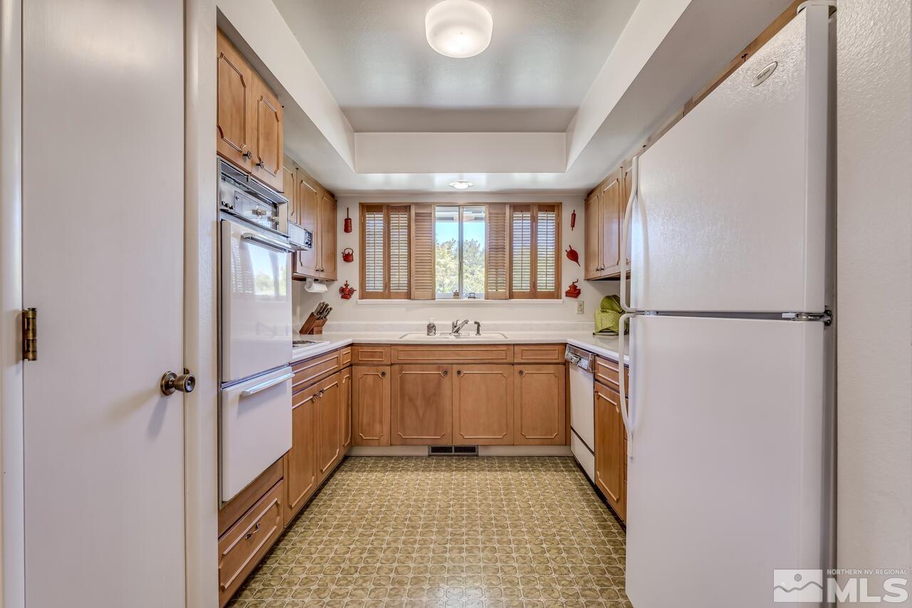 1290 Belford Road Reno, NV 89509 - Photo 11 of 33 a kitchen with a refrigerator and a sink