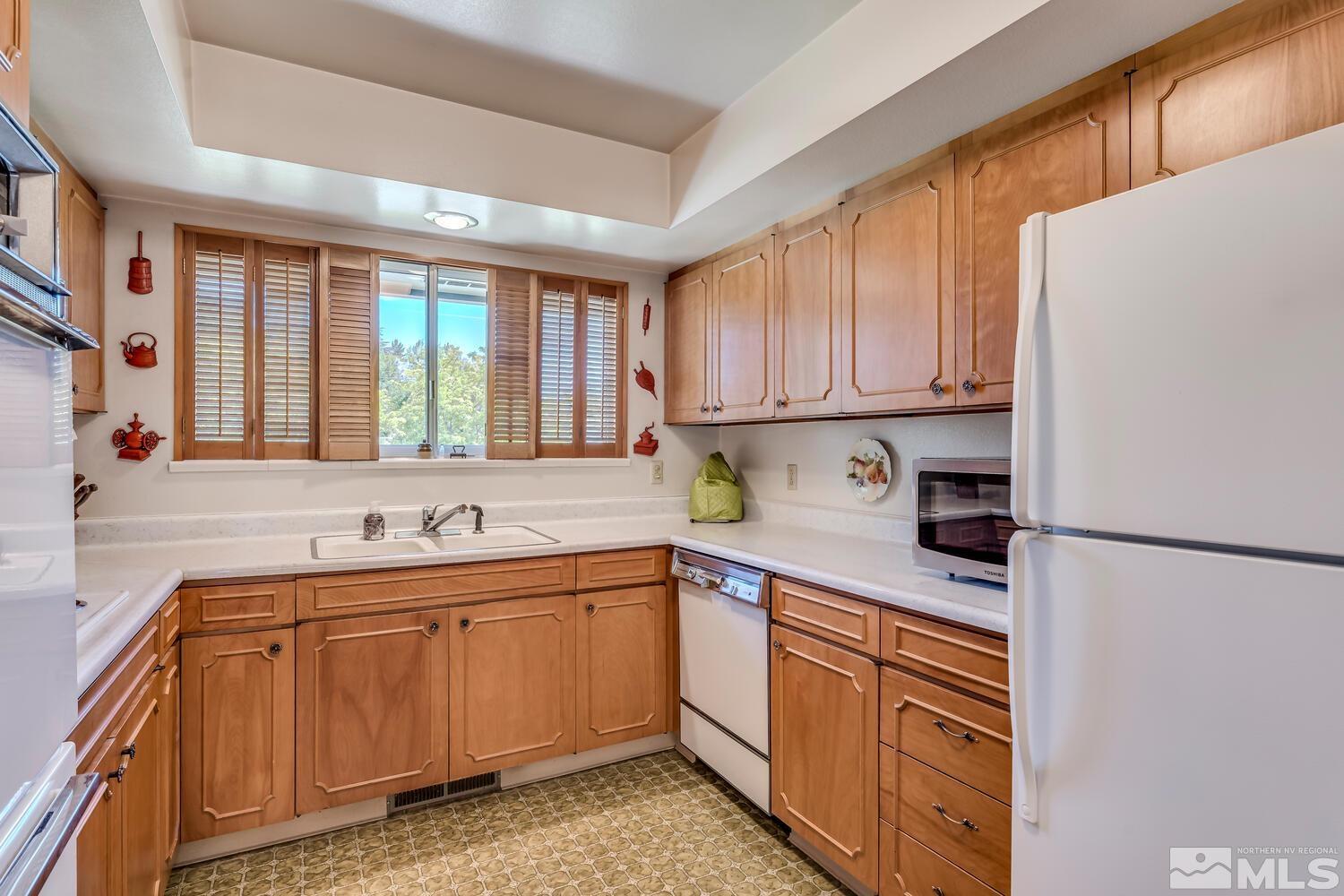 1290 Belford Road Reno, NV 89509 - Photo 13 of 33 a kitchen with a sink a stove and cabinets