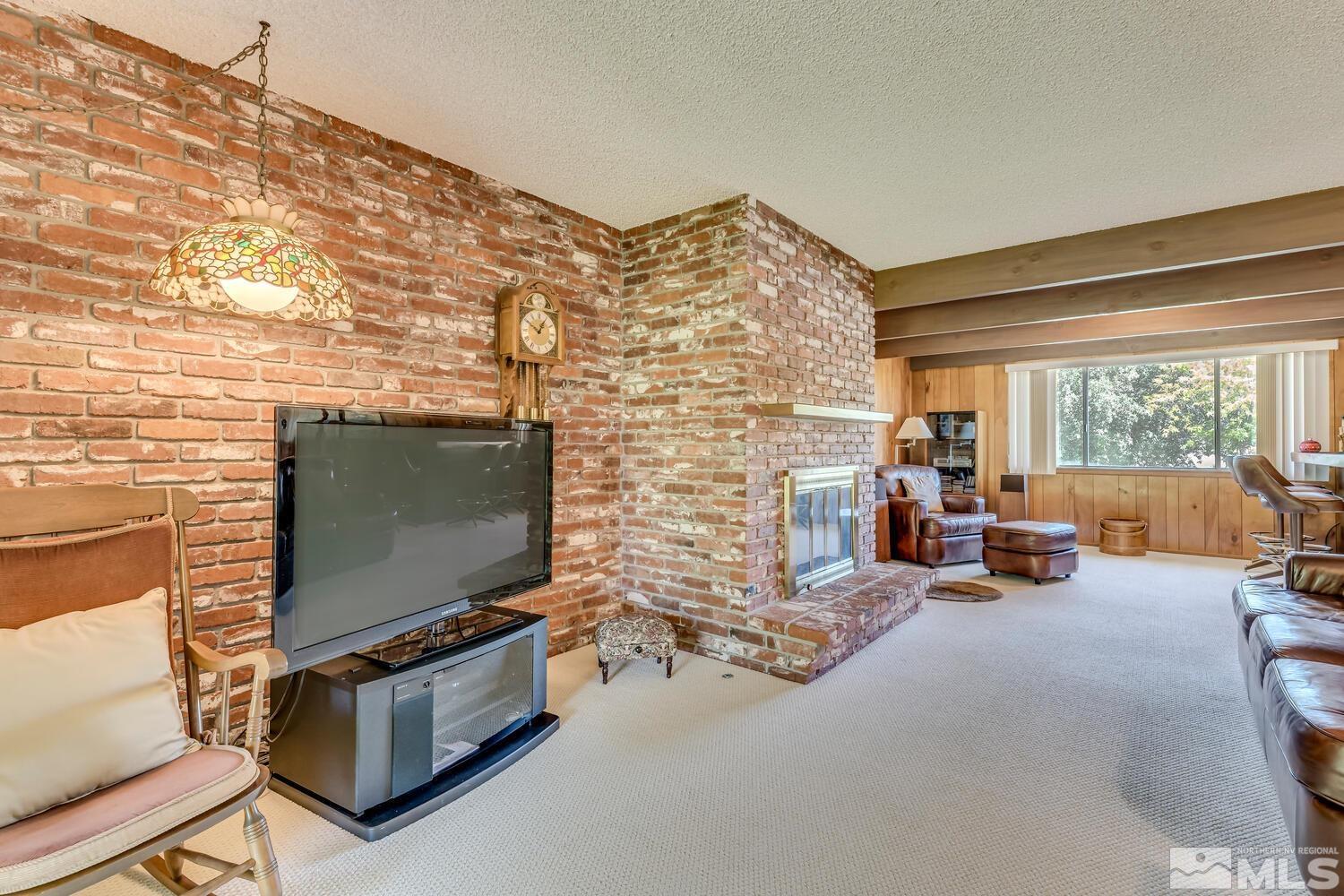 1290 Belford Road Reno, NV 89509 - Photo 15 of 33 a living room with fireplace furniture and a flat screen tv