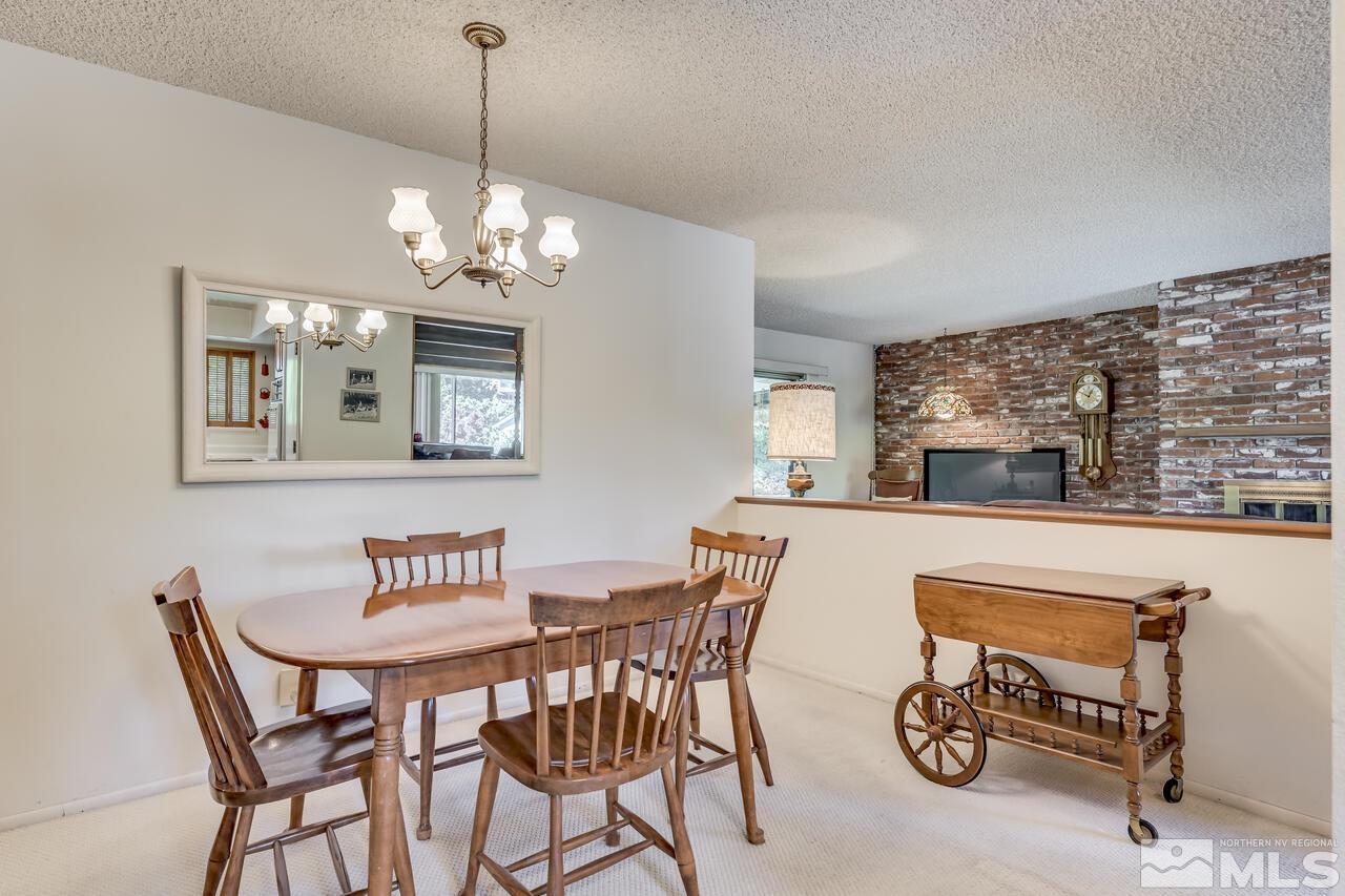 1290 Belford Road Reno, NV 89509 - Photo 8 of 33 a view of a dining room with furniture a chandelier and wooden floor