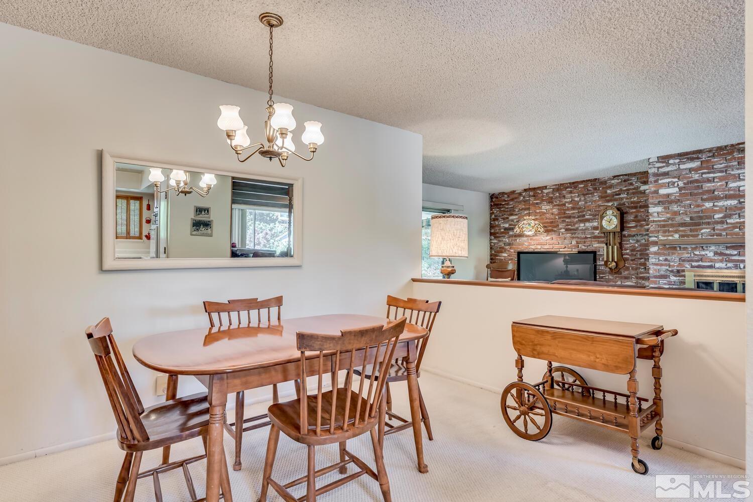 1290 Belford Road Reno, NV 89509 - Photo 9 of 33 a view of a dining room with furniture a chandelier and wooden floor