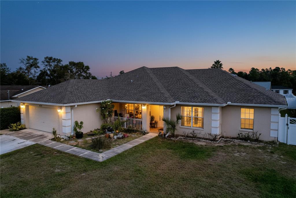 a backyard of a house with table and chairs