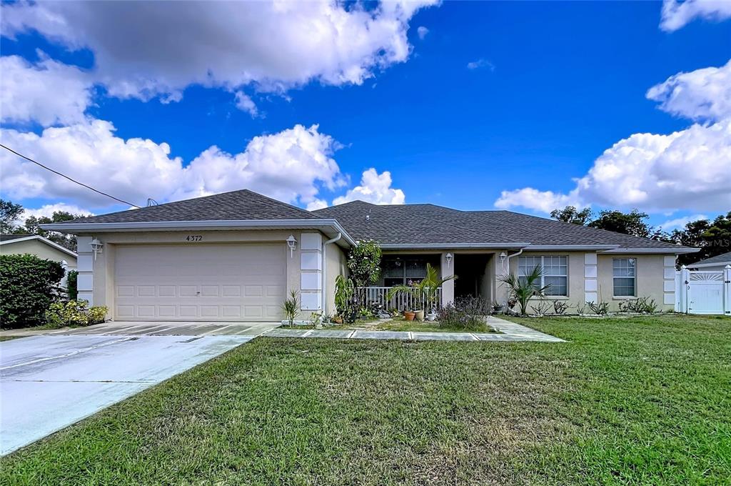 4372 Odin Street Spring Hill, FL 34608 - Photo 1 of 38 a front view of a house with garden
