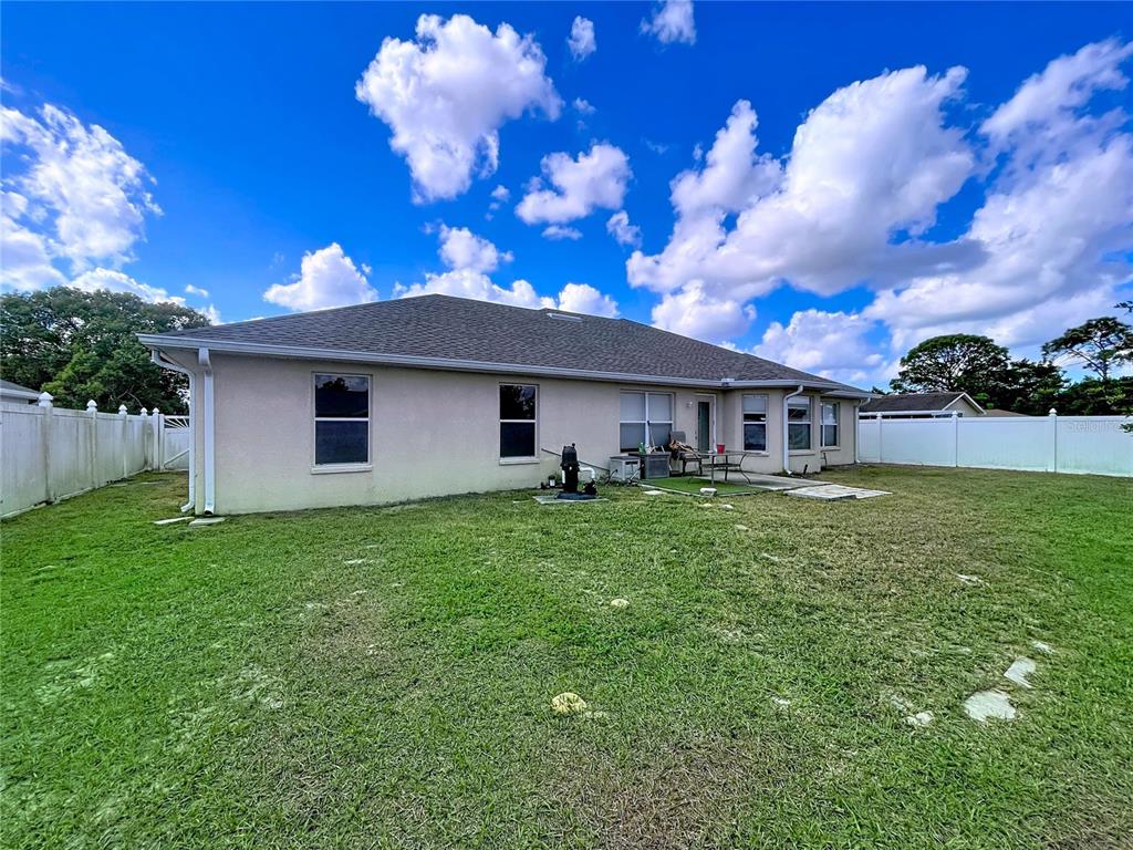 4372 Odin Street Spring Hill, FL 34608 - Photo 14 of 38 a front view of a house with a garden