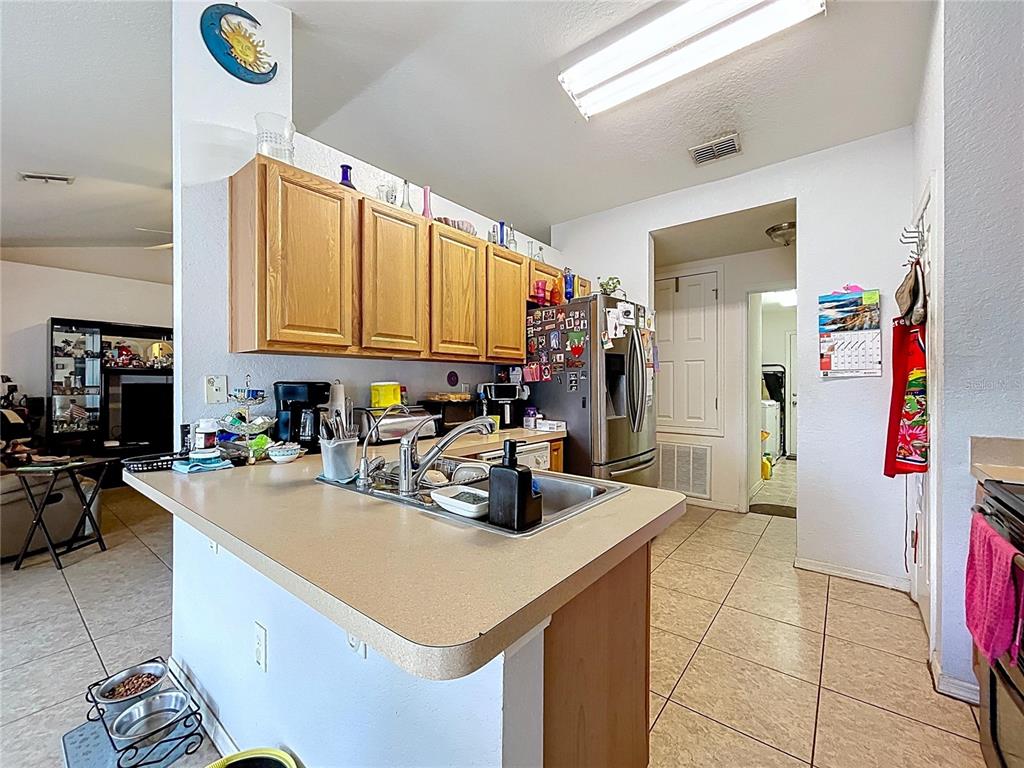 4372 Odin Street Spring Hill, FL 34608 - Photo 16 of 38 a kitchen with a sink a stove and cabinets