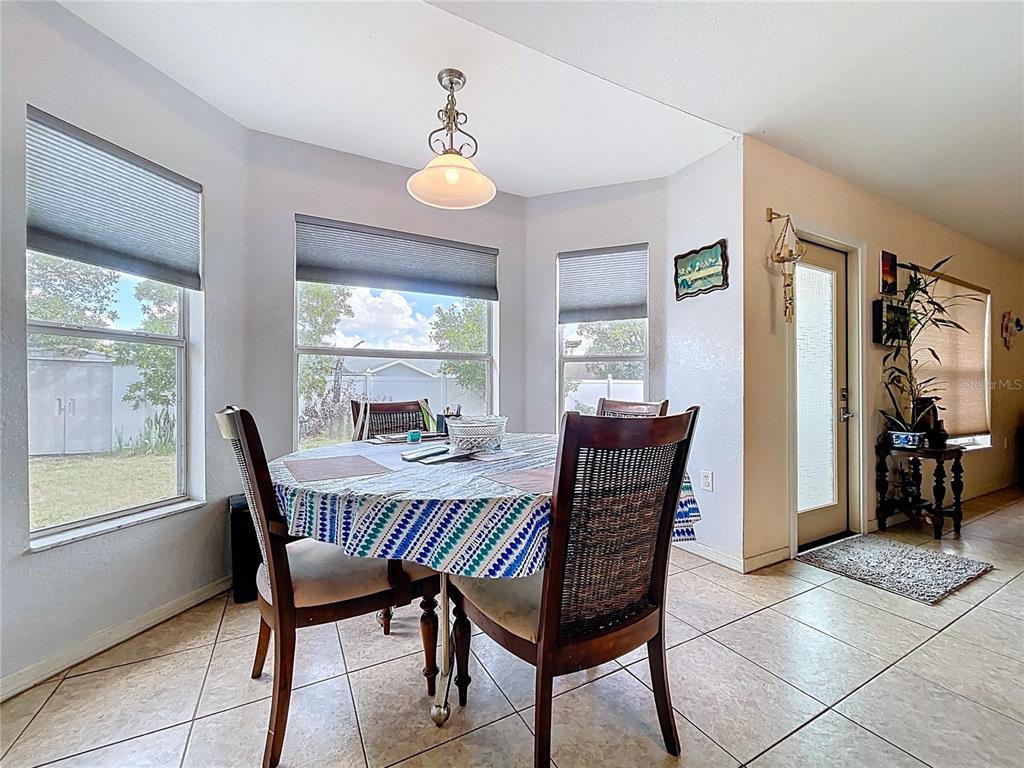 4372 Odin Street Spring Hill, FL 34608 - Photo 18 of 38 a view of a dining room with furniture and window