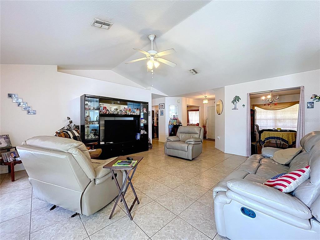 4372 Odin Street Spring Hill, FL 34608 - Photo 19 of 38 a living room with furniture and a flat screen tv