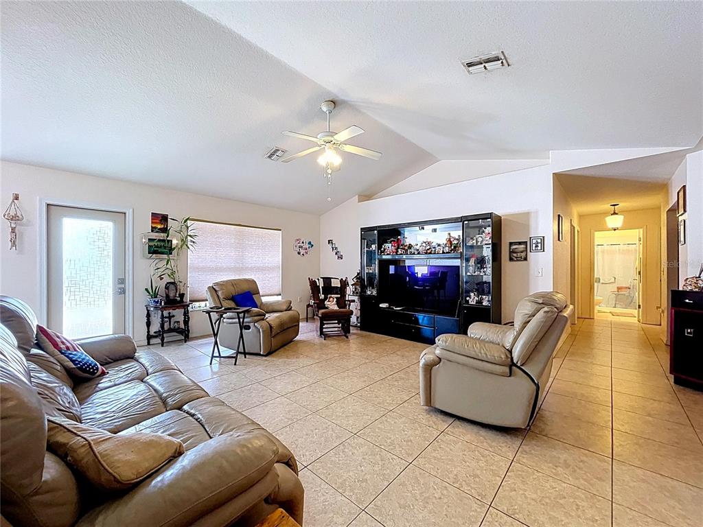 4372 Odin Street Spring Hill, FL 34608 - Photo 20 of 38 a living room with furniture and a flat screen tv