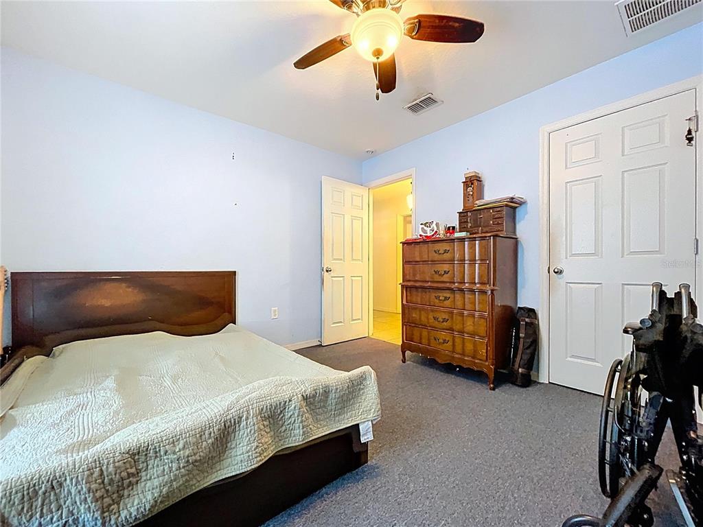 4372 Odin Street Spring Hill, FL 34608 - Photo 21 of 38 a bedroom with a bed and furniture