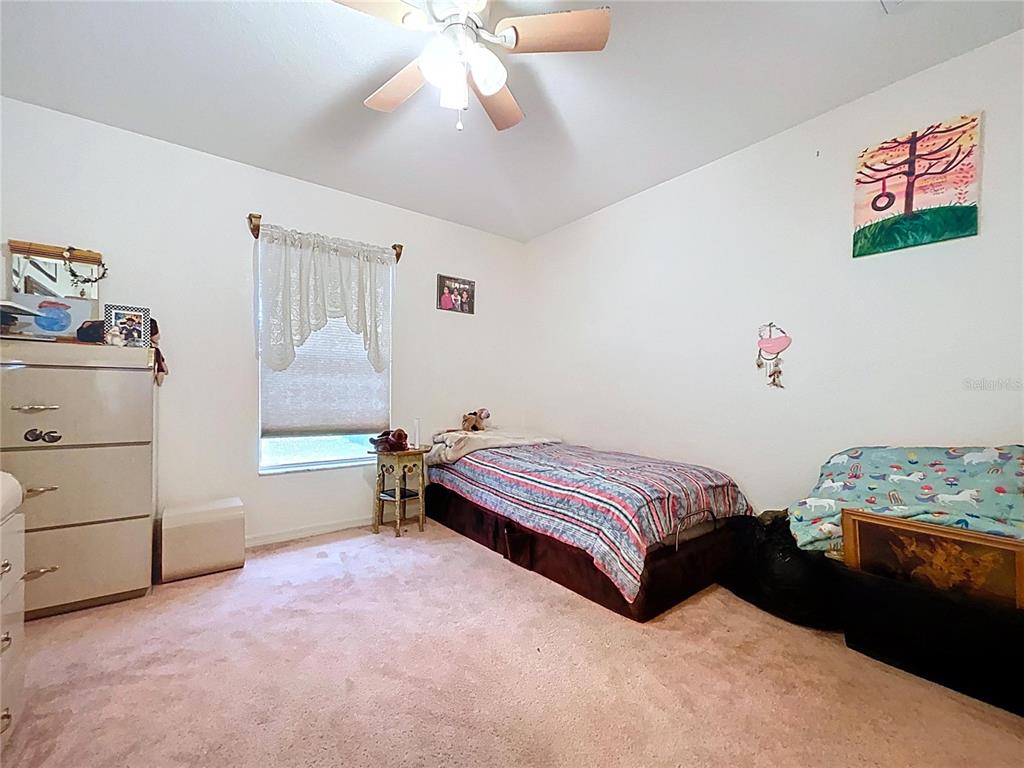 4372 Odin Street Spring Hill, FL 34608 - Photo 24 of 38 a bedroom with a bed and a window