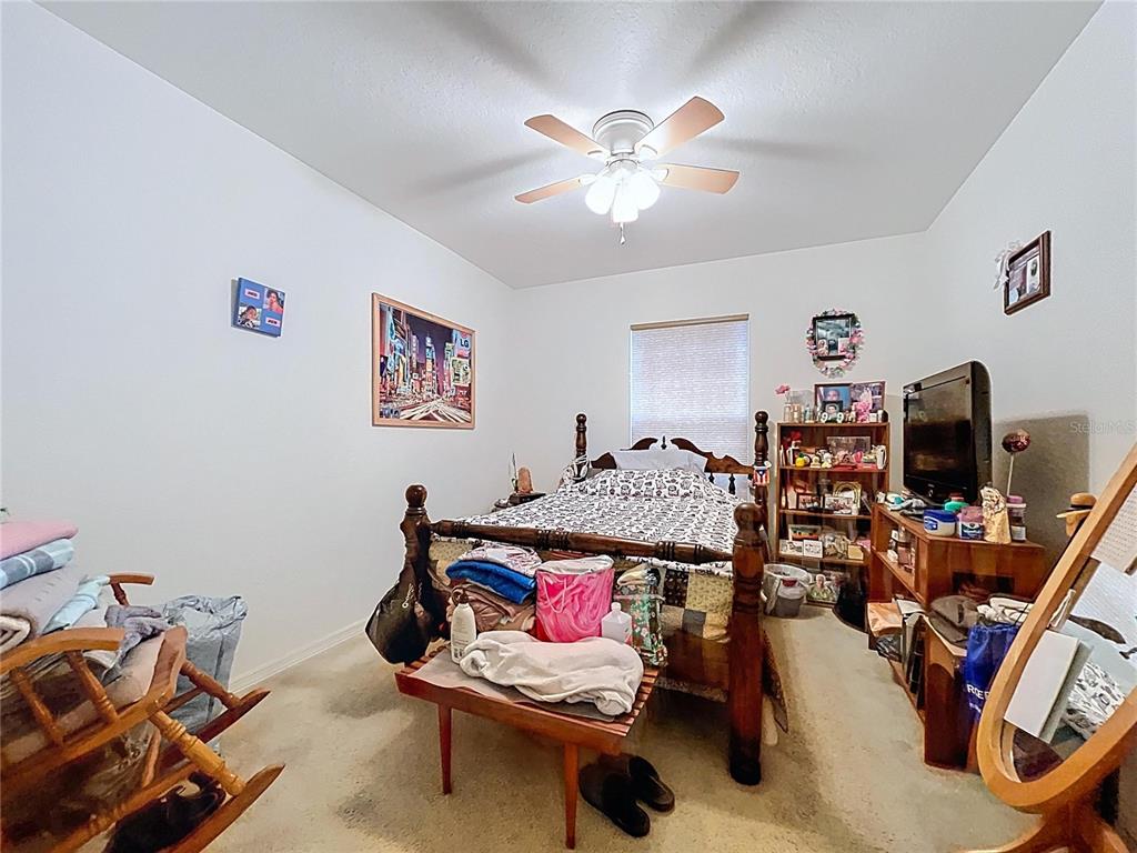 4372 Odin Street Spring Hill, FL 34608 - Photo 27 of 38 a living room with furniture and a flat screen tv