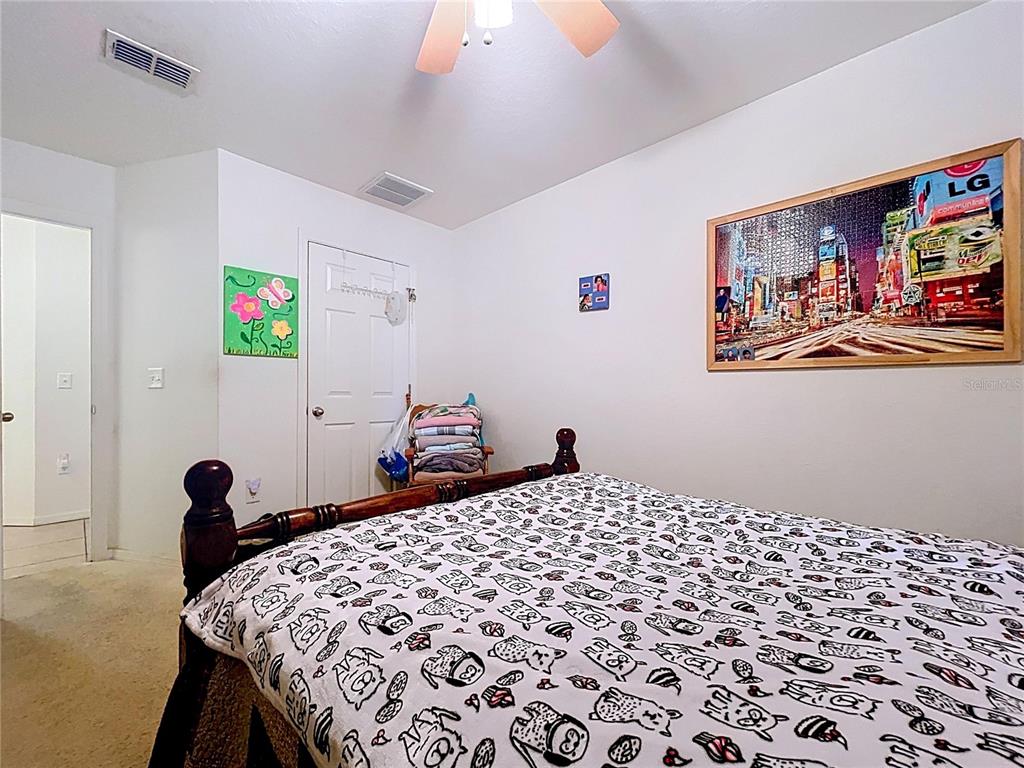 4372 Odin Street Spring Hill, FL 34608 - Photo 28 of 38 a bedroom with a bed and a painting on the wall