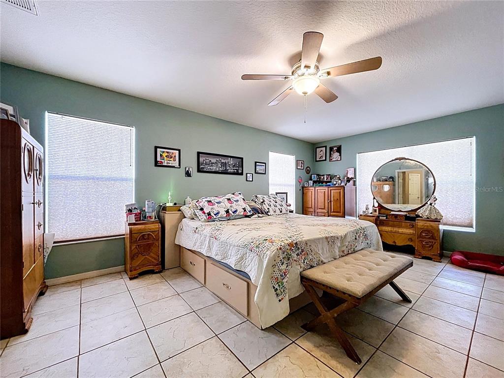 4372 Odin Street Spring Hill, FL 34608 - Photo 29 of 38 a bed room with a bed and a chandelier