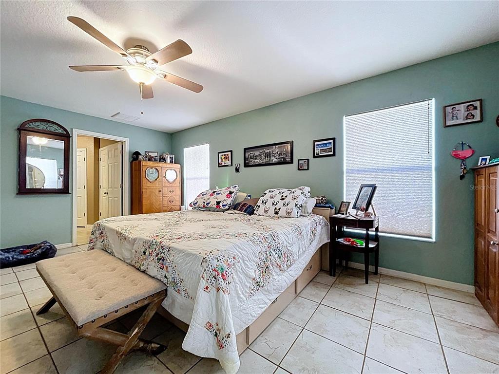 4372 Odin Street Spring Hill, FL 34608 - Photo 31 of 38 a bedroom with a bed and a table in it