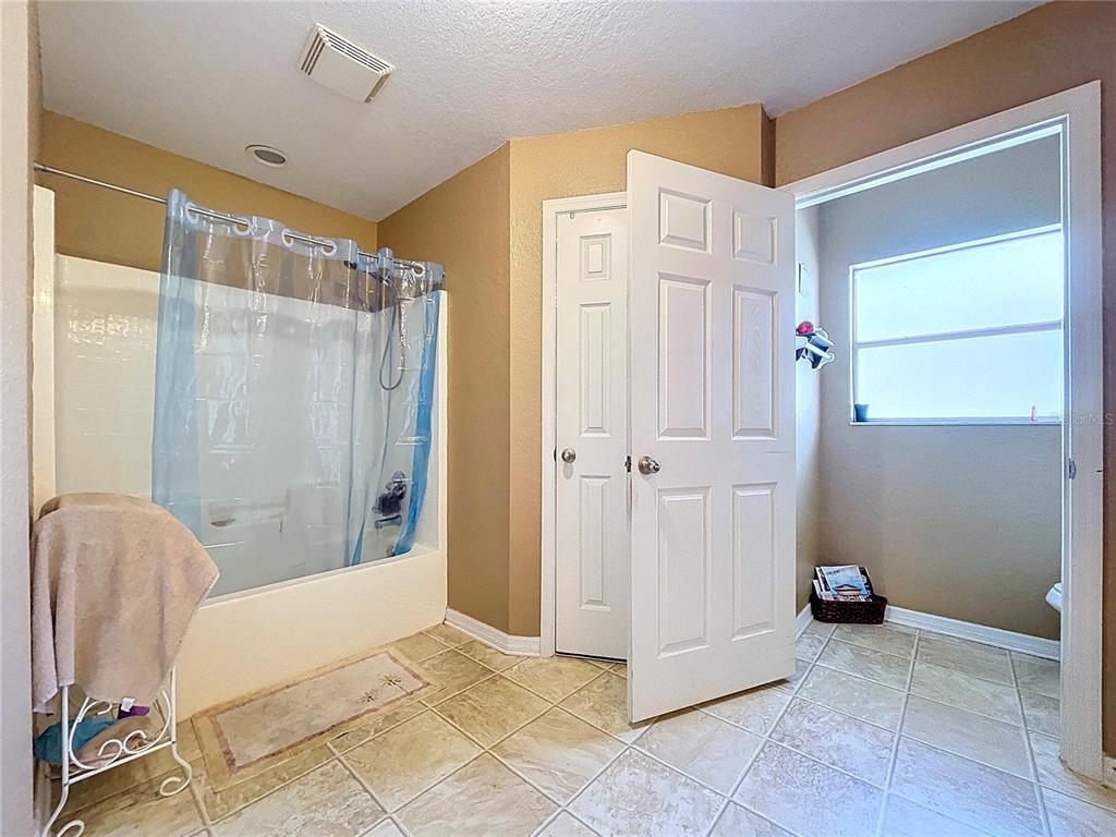 4372 Odin Street Spring Hill, FL 34608 - Photo 33 of 38 a view of a bathroom with tub and shower