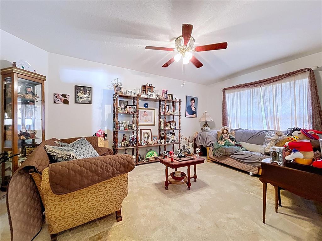 4372 Odin Street Spring Hill, FL 34608 - Photo 6 of 38 a living room with furniture and a flat screen tv