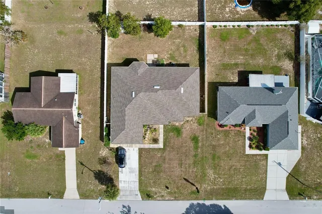 an aerial view of a house with a yard