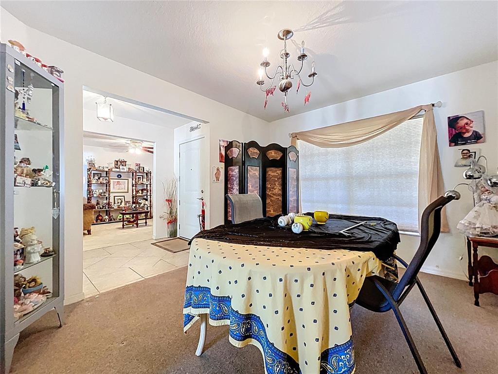 4372 Odin Street Spring Hill, FL 34608 - Photo 7 of 38 a living room with furniture and a chandelier