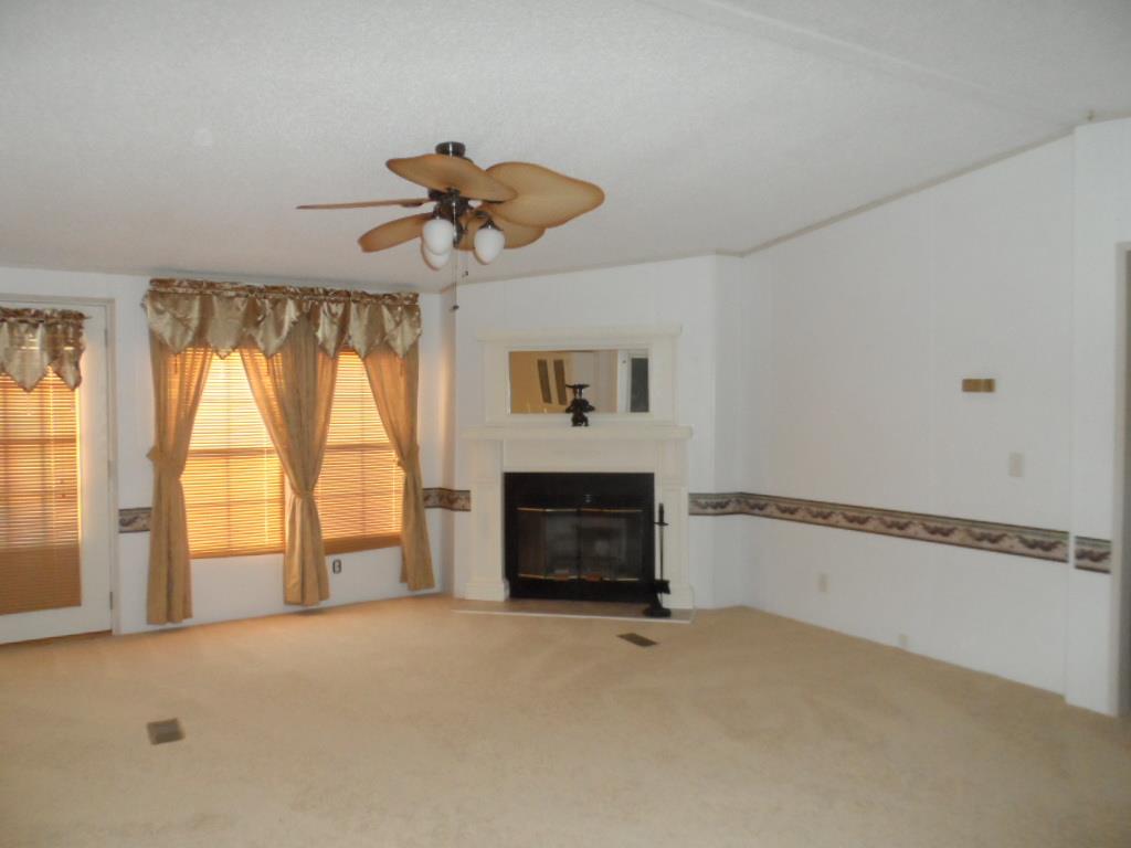 140 East Biggs Road Portland, TN 37148 - Photo 3 of 10 a view of an empty room with a fireplace and a window