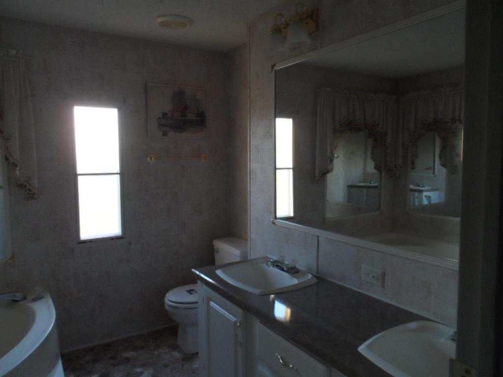 140 East Biggs Road Portland, TN 37148 - Photo 10 of 10 a bathroom with a toilet sink and mirror