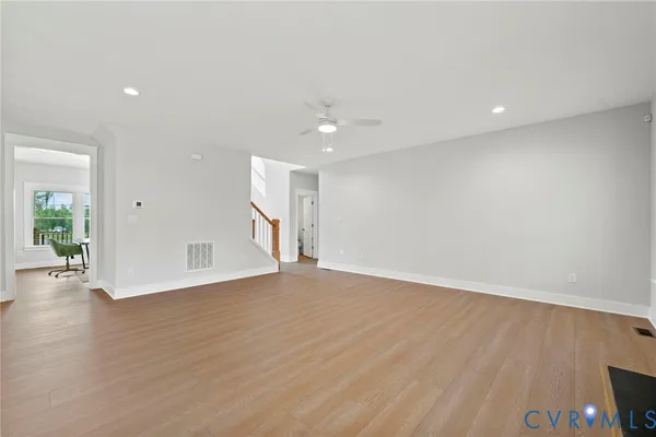 wooden floor in an empty room with a window