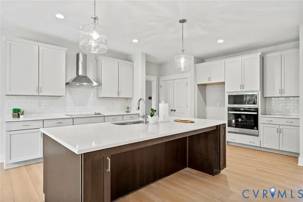 a kitchen with kitchen island granite countertop a sink and refrigerator