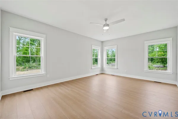 a view of an empty room and wooden floor