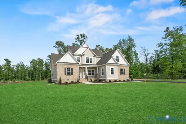 a front view of a house with a yard and trees